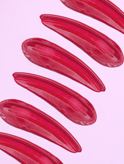 lipstick smear sample lip gloss on pink background