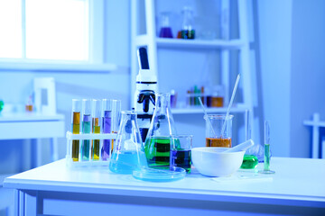 Different chemical glassware on table in medical laboratory