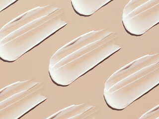 pattern cosmetic smears of creamy texture on a pastel beige background	
