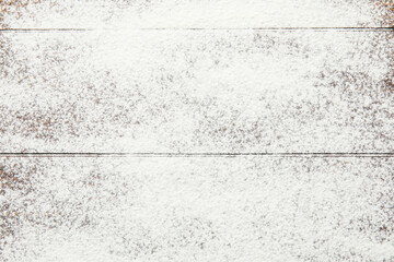 Scattered wheat flour on wooden background