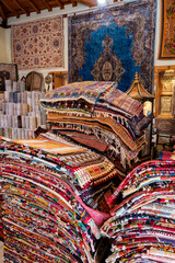 Large stacks of oriental  rugs in a store. Colorful carpet market. Turkey