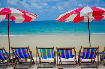 Beach chairs with umbrella on the beach with blue sky.