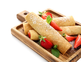 Board with thin pancakes, strawberries and mint leaves on white background