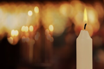 Flame candles on a Christian Orthodox dark church background.