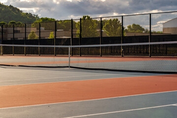 Fototapeta premium New blue tennis courts with white lines and red out of play area. 