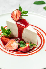 Strawberry Cheesecake with Strawberry Syrup. piece of cheesecake decorated with strawberry sauce on white background