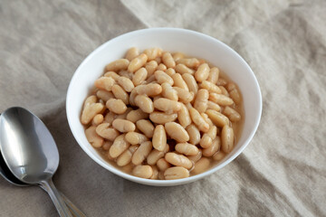 Organic White Cannellini Beans in a White Bowl, low angle view.