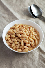 Organic White Cannellini Beans in a White Bowl, low angle view.