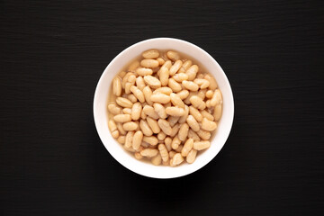 Organic White Cannellini Beans in a White Bowl, top view. Flat lay, overhead, from above.