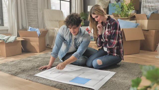 new house project couple planning renovation of the new home on blueprint layout,young people plan to renew the apartment,rent purchase mortgage concept