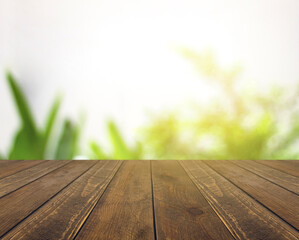Abstract blurred green natural and brown wooden tabletop texture perspective counter for promoting and advertising product on display
