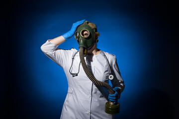doctor woman in gas mask and gloves is annoyed and holding her head on a blue background