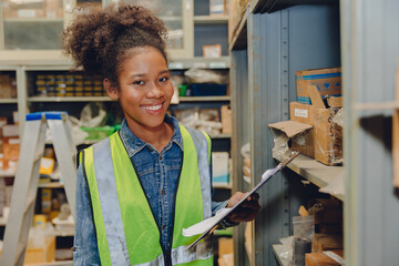 Black African women warehouse staff worker manage factory products goods and shipping to customer.
