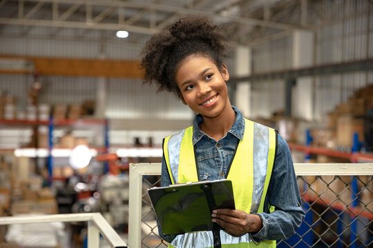 Black African women warehouse staff worker manage factory products goods and shipping to customer.