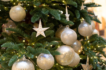 Decoration with a green branch of a Christmas tree with a ball and a star. Sparkling shining festive new year background