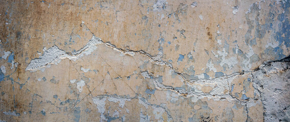 The texture of an old white wall with cracks.