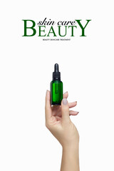 Cosmetology and beauty skincare advert. Beautiful manicured female hand holding up unlabelled green dropper bottle with cosmetic fluid.