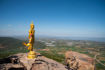 golden buddha image on the hill with clear sky  background