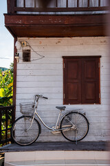 Fototapeta na wymiar retro bicycle in front of old wooden house.