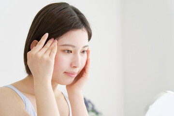 リビングでスキンケアをする女性