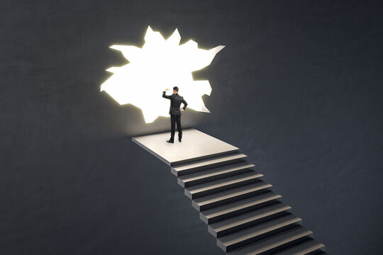 European Businessman On Stairs Looking Out Of Hole In Broken Wall Into A Bright Future. Market Research, Success, Tomorrow And Crisis Ideas Concept.