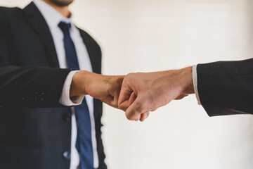 Congrats, business partnership people, two asian and caucasian young man fist bumping, shaking hands together with partnership, customer or colleague after work is done, successful. Worker meeting.