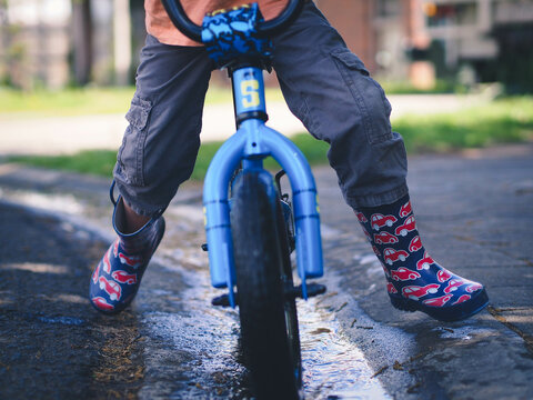 Lower view of child riding a bike