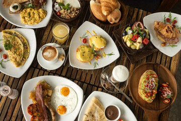 many mixed western breakfast food items on cafe table