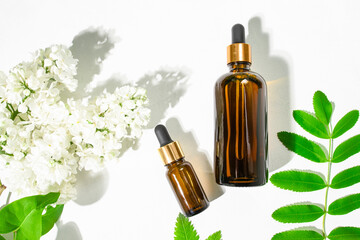 Two brown glass bottles with a natural cosmetic product. Essential oils and body serum with natural ingredients top view.