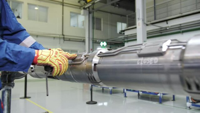 specialist inspects oil drilling pipes