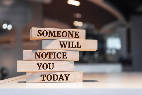 Wooden blocks with words 'Someone will notice you today'.