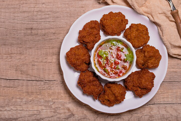 Fried Pork Cake with Ketchup and Chili Sauce on a white table top view. Asia Travel Cuisine concept.