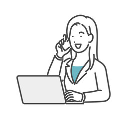 パソコンを見ながら電話する女性