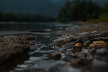 A seething mountain river flows rapidly through large stones