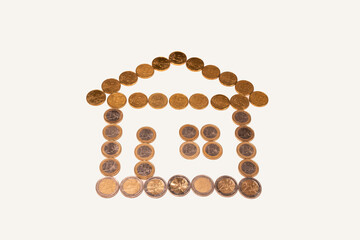 House shaped with one euro and fifty cent coins. Symbol of home loans, mortgages and real estate financing. Currency of the European Union. 