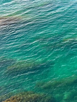 Sea turquoise water surface with ripples background.