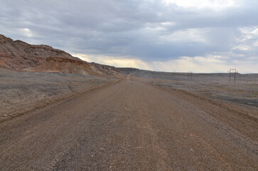 Fototapeta na wymiar Crystal Geyser gravel road in the desert of southern Utah near Green River
