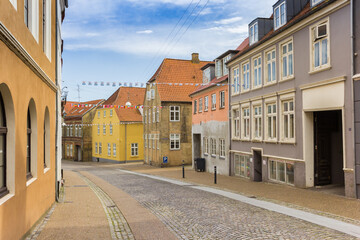 Fototapeta na wymiar Empty cobblestoned street in the historic center of Haderslev, Denmark
