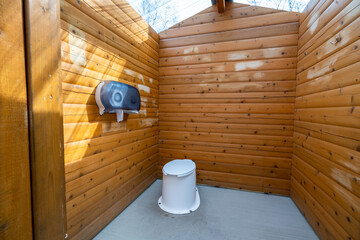 Interior of wooden public lavatory in the Jasper National Park, Alberta, Canada. Countryside toilet...