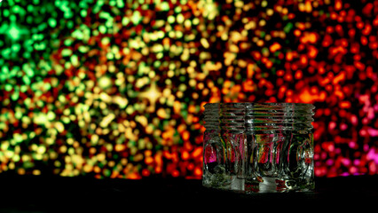 glass beaker on a background of glowing glitter