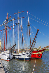 Fototapeta na wymiar Historic tall ships on the IJssel river in Kampen, Netherlands