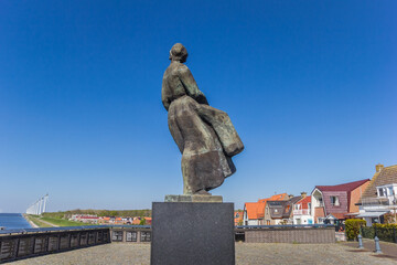 Statue of a woman looking back to the sea in Urk, Netherlands - obrazy, fototapety, plakaty