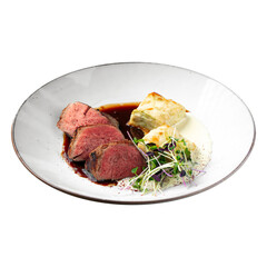Isolated portion of sous-vide veal with potato gratin