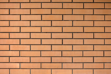 Brick-red wall. Orange brick wall background.