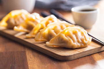 Chinese dumplings on cutting board.