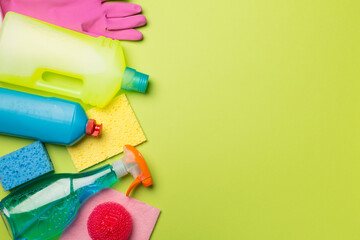 Many different house cleaning products on color background, top view