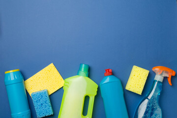 Many different house cleaning products on color background, top view
