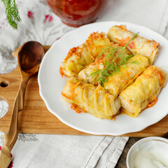 Stewed stuffed cabbage Ukrainian cuisine with dill wooden spoon national style