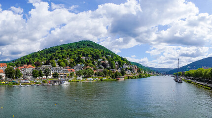 Fototapeta premium View of Heidelberg with the hilly landscape and the Neckar from the Theodor-Heuss Bridge. 