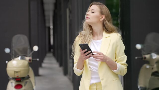Young woman using smartphone on street